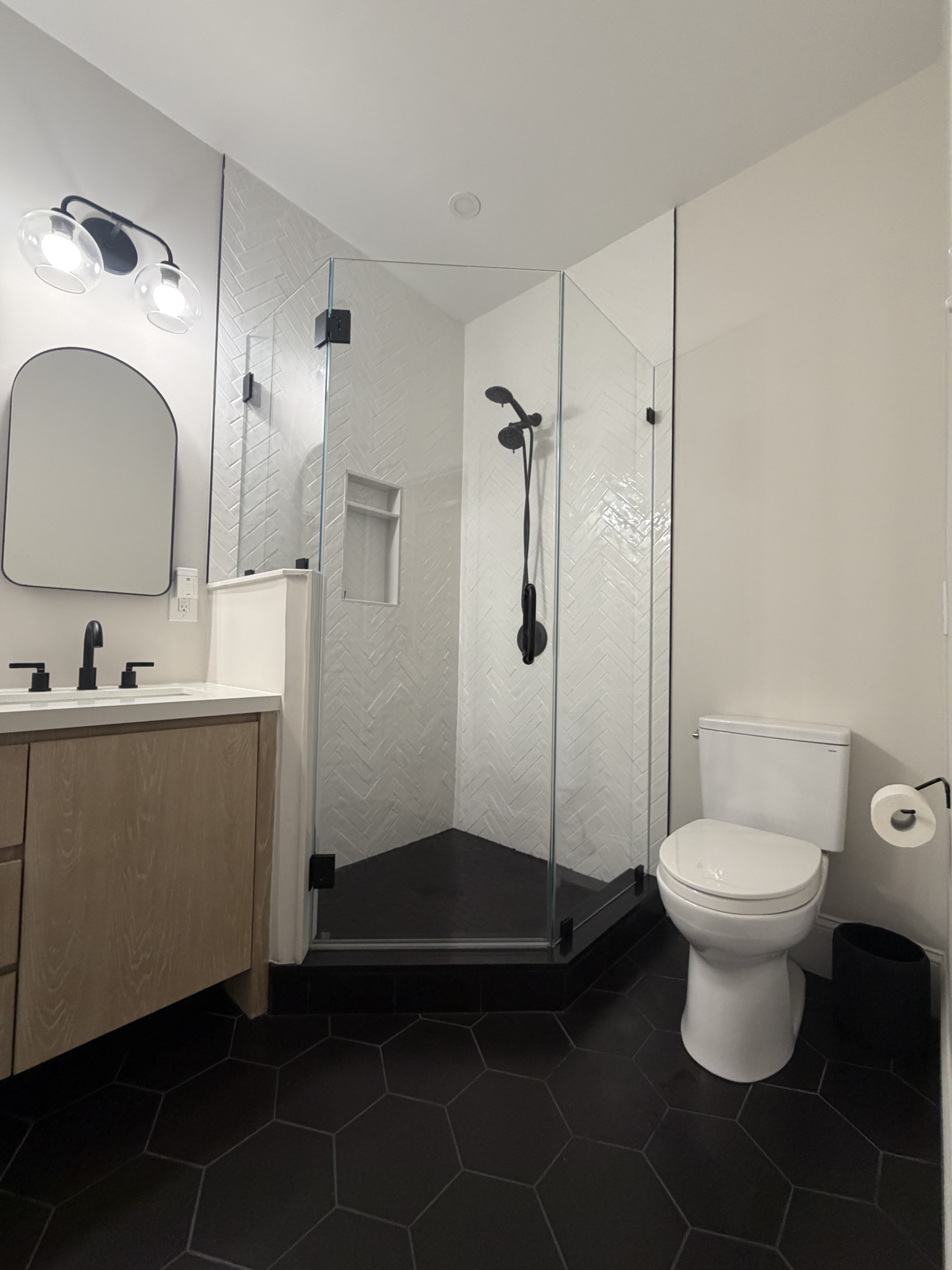 Neo angle corner shower door installed in Greater Boston bathroom by LUXE Glass