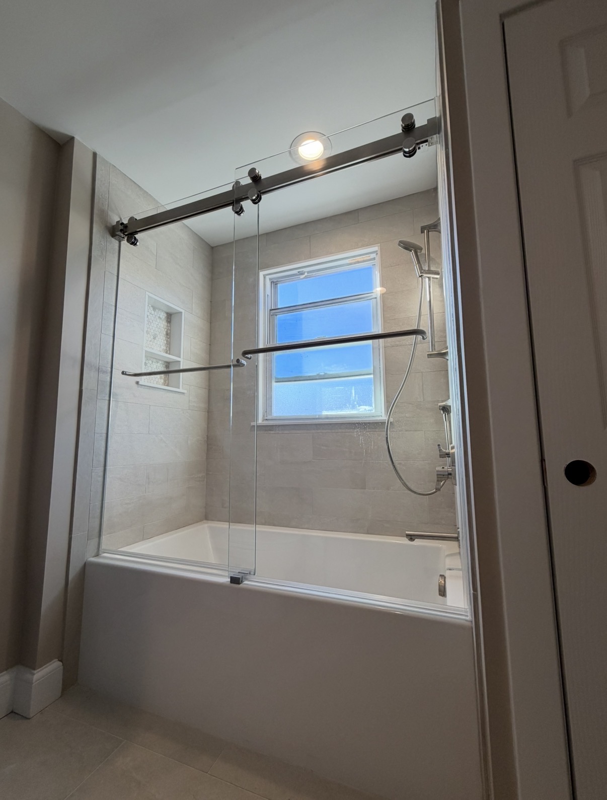 Custom glass bathtub enclosure installed in Greater Boston by LUXE Glass