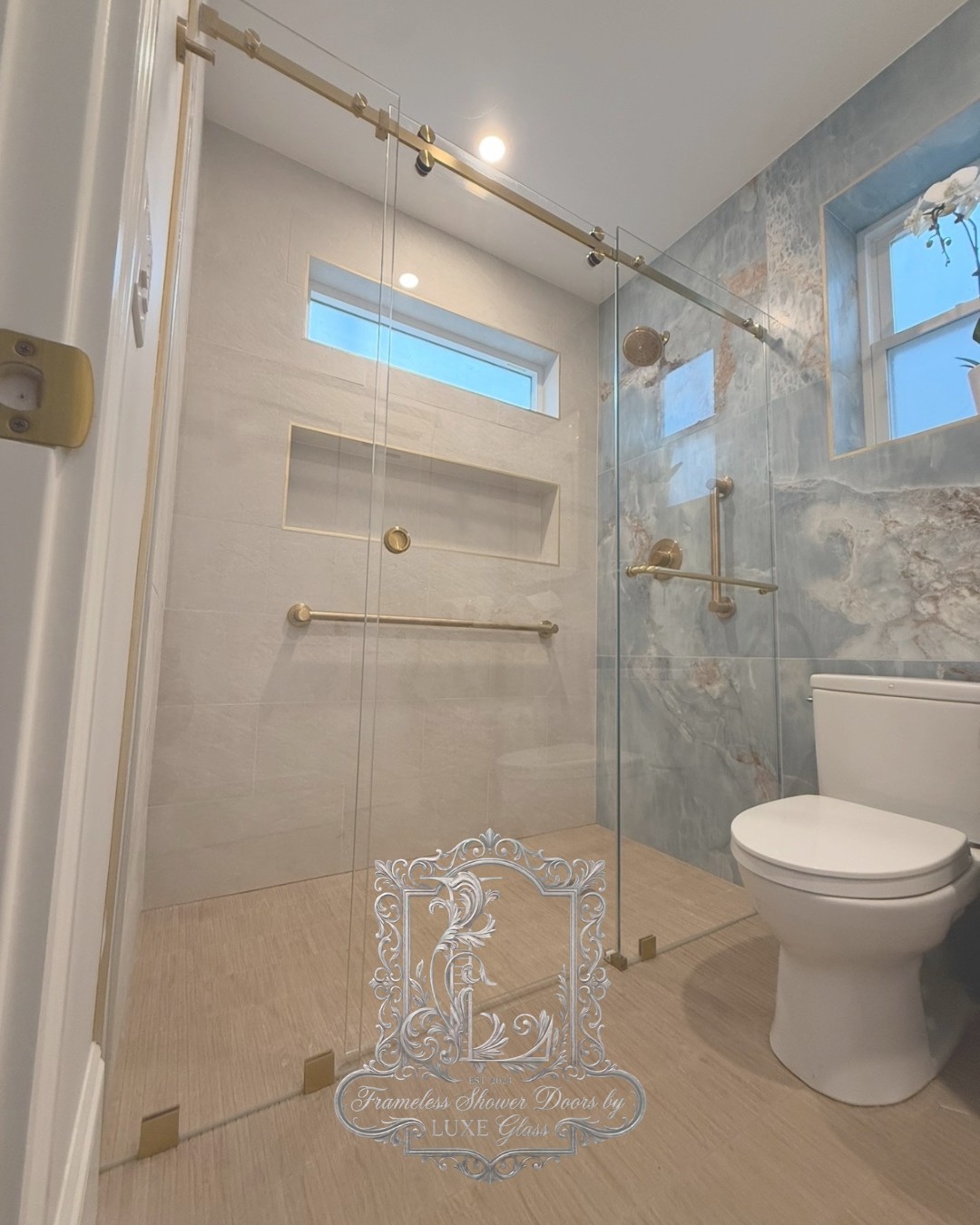 Sliding frameless shower doors installed near Winchester MA by LUXE Glass