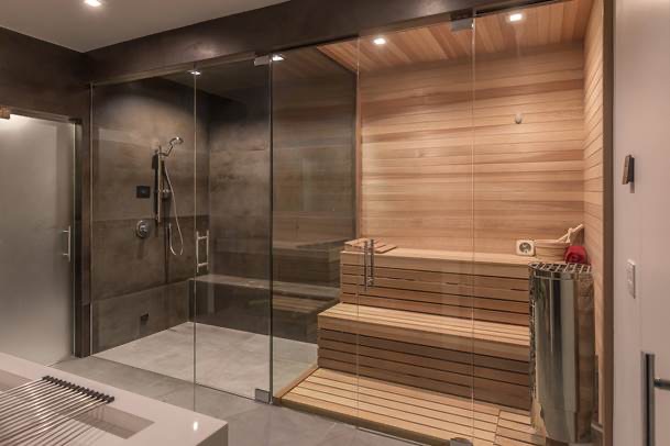 Custom frameless glass steam shower with premium black hardware installed by Frameless Shower Doors by Luxe Glass in Greater Boston.